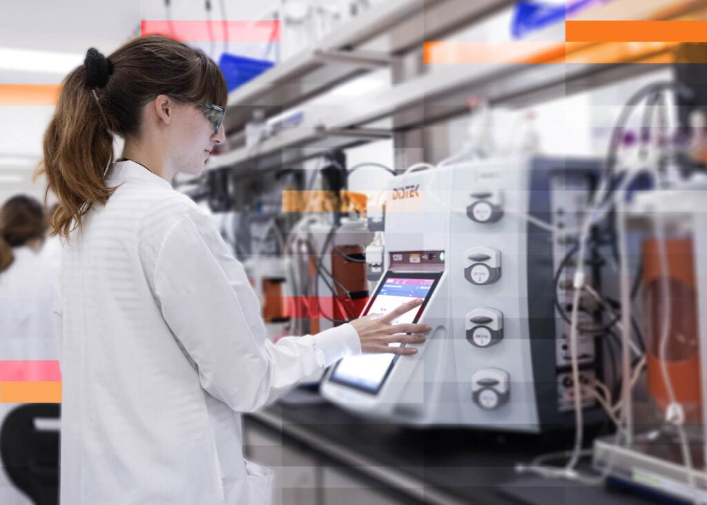 A scientist at Forge Biologics programming lab equipment.