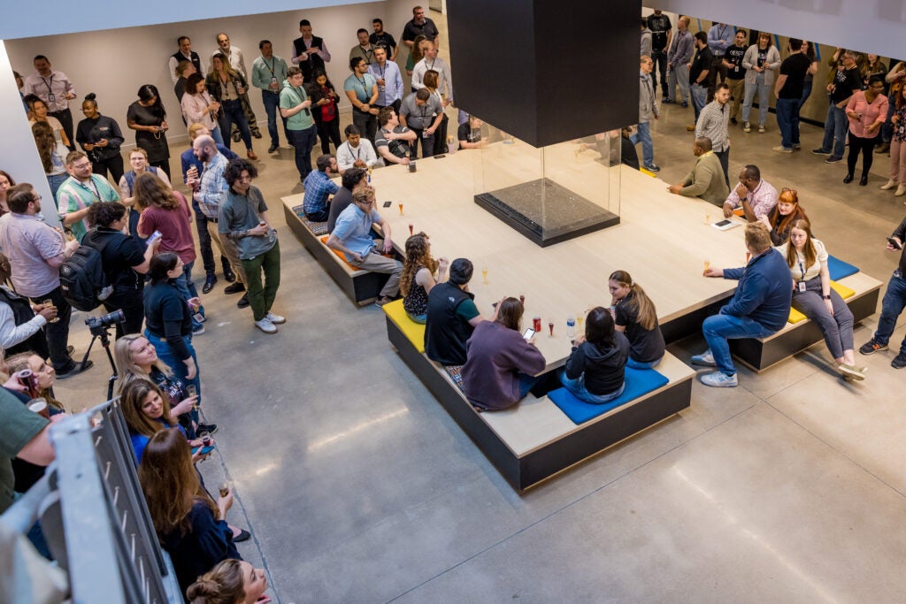The Forge team gathered around the Foundry at the Hearth during a company-wide event.