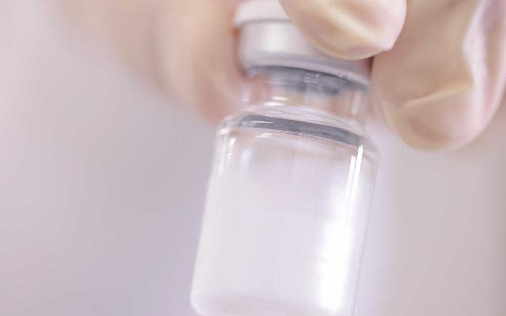 The hand of a scientist at Forge Biologics holding a test tube with drug substance.